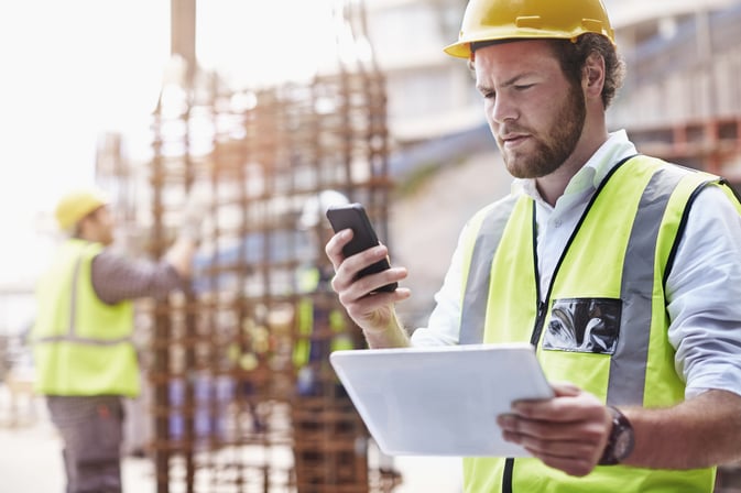 Construction Worker Checking in on his Phone