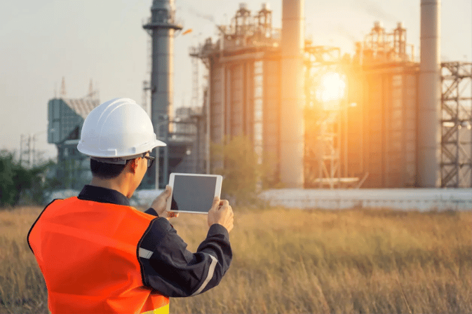 Worker with Tablet outside of Plant