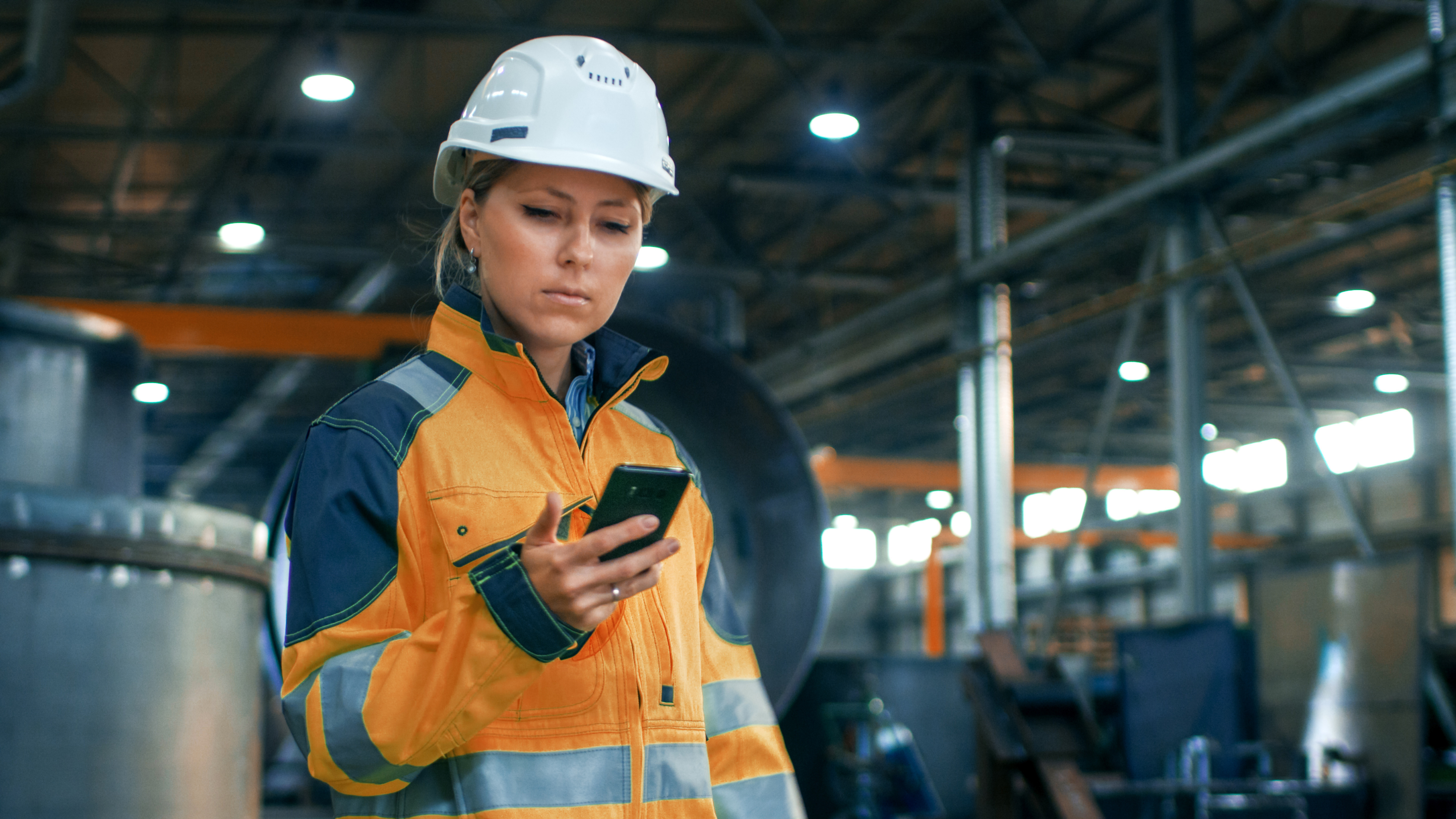 Worker on Phone AdobeStock_182072893 BRIGHT ORANGE-1